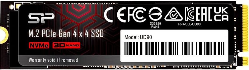 Фото-1 SSD Silicon Power UD90 2TB M.2 2280, вид сверху на сторону с наклейкой; чёрная плата, декоративная чёрно-красная этикетка SP, белый серийный стикер и справа интерфейсный разъём M.2; фото показывает лицевую сторону накопителя.