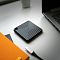 Фото-2 Внешний SSD Silicon Power PC60 2TB на столе рядом с ноутбуком, вид сверху: чёрный корпус с рельефной поверхностью и кабель USB‑C отдельно; показывает сценарий подключения переносного SSD.