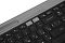 Фото-6 Клавиатура Logitech K580 920-009208, вид сзади под углом: чёрный корпус, серебристая планка и длинный паз для смартфона или планшета по верхнему краю; изображение на светлом фоне для карточки товара, показывает заднюю кромку и глубину встроенной подставки.
