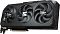 Фото-3 Видеокарта GIGABYTE AMD Radeon RX 9070 XT, вид сверху под углом со стороны портов; на фото три вентилятора, серебристая интерфейсная планка, видны видеовыходы и край радиатора; изображение показывает компоновку корпуса и выходной панели.
