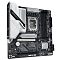 Фото-3 Материнская плата GIGABYTE Z890M GAMING X &mdash; ракурс под углом; показаны кожух задней панели с подсветкой GAMING, сокет LGA1851 и 4 слота DDR5, радиаторы серебристого цвета и зона M.2; на белом фоне, чтобы на странице товара было видно профиль радиаторов и общий вид платы.