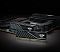Фото-7 Комплект памяти ADATA XPG Lancer Blade AX5U6000C3616G-DTLABBK, две планки рядом с материнской платой на тёмном фоне. Показаны фронтальные панели радиаторов, диагональная текстура и контактные края. Чёрный цвет. Фото важно для страницы товара, так как показывает комплект в контексте совместимой платформы.