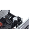 Фото-3 Блок питания для ПК XPG Core Reactor II VE 850W - крупный план внутренней части через открытую крышку: радиаторы, конденсатор и элементы платы рядом с панелью разъёмов; чёрный корпус, фото показывает внутреннюю компоновку устройства