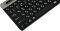 Фото-3 Клавиатура A4Tech Fstyler FBK25 Black, крупный план левой части сверху: чёрные квадратные клавиши с русско-латинской раскладкой, модификаторы Alt/Cmd и начало серой планки с пазом для установки устройства; изображение на белом фоне для карточки товара, показывает форму кейкапов и левую часть раскладки.
