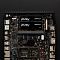 Фото-7 Комплект памяти Kingston FURY Impact PnP KF548S38IBK2/16, два SO-DIMM-модуля установлены на плате компактного ПК. Показаны защёлки слотов, открытая системная плата, разъёмы по краям и лицевые наклейки модулей. Чёрный цвет. Изображение показывает, как комплект выглядит после установки в компактное устройство.