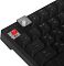 Фото-19 Механическая клавиатура MSI Forge GK320, крупный план снятой клавиши; под кейкапом виден красный механический переключатель в прозрачном корпусе, рядом клавиши F1–F3 и Tab, чёрные кейкапы; изображение показывает конструкцию переключателя на странице товара.