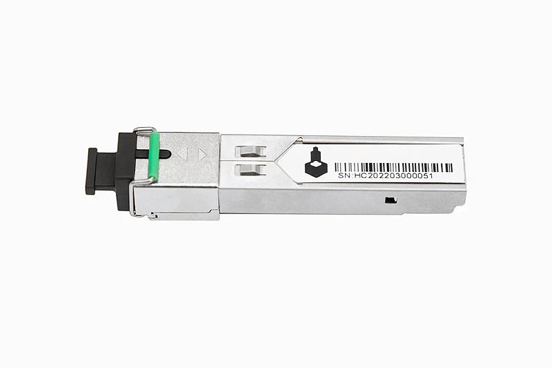 Фото-1 Трансивер SFP NST NS-SFP-S-SC53-G-3, вид под углом: металлический модуль с чёрной заглушкой на оптическом торце и зелёной откидной защёлкой; на корпусе наклейка со штрих‑кодом. На белом фоне для карточки товара, чтобы визуально различать вариант модели и тип оптического подключения.