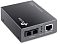 Фото-2 Медиоконвертер TP-Link MC210CS, вид сверху и спереди под углом с другой стороны: оптические порты 1000BASE‑LX и порт RJ‑45, три зелёных индикатора; тёмно-серый корпус на белом фоне — помогает сравнить размещение разъёмов.
