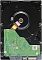 Фото-2 Жёсткий диск 3.5" Western Digital WD Purple WD43PURZ — вид снизу, зелёная плата электроники на чёрном основании и оранжевый шлейф, у нижней кромки видны SATA‑контакты; на белом фоне; важно для понимания расположения разъёмов и платы при установке.