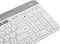 Фото-7 Клавиатура Logitech K580 920-009209, нижняя панель: белое основание с серой верхней частью, продолговатыми резиновыми ножками и сервисной наклейкой в центральной зоне; изображение на светлом фоне для карточки товара, показывает конструкцию основания и опорные элементы.