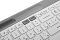 Фото-8 Клавиатура Logitech K580 920-009209, нижняя панель крупным планом: белое основание, серый верх, наклейка с моделью K580 и сертификационной маркировкой, рядом резиновая ножка; изображение на светлом фоне для карточки товара, показывает заводскую маркировку на обратной стороне.