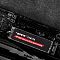 Фото-7 SSD Patriot Viper VP4300 Lite 2TB M.2 2280, демонстрация в материнской плате; накопитель установлен в слот M.2, вокруг видны разъёмы питания, конденсаторы и кожух видеокарты; тёмный фон, фото показывает монтаж и контекст использования на странице товара.