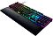 Фото-5 Клавиатура Razer Huntsman V2, вид под углом сверху слева с подставкой для запястий; видны многоцветная подсветка, высокий профиль кейкапов, цифровой блок и широкая подставка перед корпусом. Для страницы товара важно, потому что изображение показывает объём клавиш и посадку рук относительно подставки.