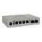 Фото-2 Коммутатор SNR S1904GP-2S, вид спереди слева под углом. Видны 4 PoE-порта, 2 SFP-слота, боковые вентиляционные прорези и цилиндрический разъём питания в металлическом корпусе серебристого цвета. Фото важно для карточки товара, потому что показывает форму корпуса и доступ к интерфейсам в объёмном ракурсе.