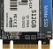 Фото-5 SSD Netac N930ES 512GB, крупный план лицевой части модуля. Видны фрагмент белой наклейки с обозначением 512GB, надпись QC PASS 05/2023, кварцевый резонатор и золотистые контакты разъёма по нижнему краю. Фото важно для страницы товара, потому что показывает маркировку и элементы платы крупно.
