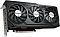 Фото-2 Видеокарта Gigabyte GeForce RTX 5070 Ti Windforce OC V2, вид спереди под углом со стороны интерфейсной планки: три чёрных вентилятора с серебристыми центральными накладками, матовый кожух и частично видимая металлическая планка с видеовыходами; для страницы товара этот ракурс показывает толщину корпуса и форму лицевой панели.