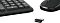 Фото-23 USB-ресивер комплекта Oklick 225M — крупный план: мини-приёмник с логотипом OKLICK, на фоне частично видны клавиатура и мышь. Для страницы набора важно как фото элемента беспроводного подключения.